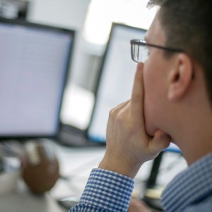 Person thinking and looking at screen