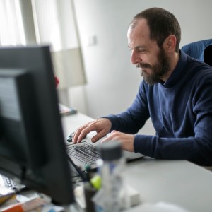 Person looking at keyboard and typing
