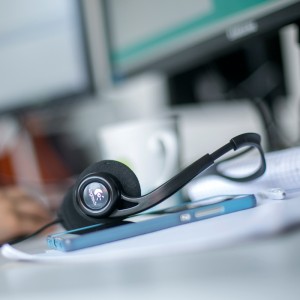 Headset on a desk near a computer keyboard