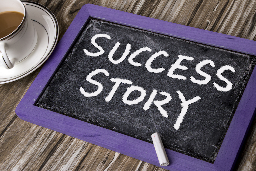 success story handwritten on blackboard